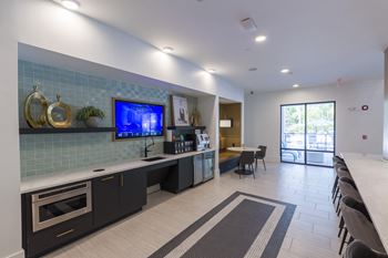 Community lounge with kitchenette and seating area