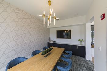 Conference room with modern chandelier and blue chairs
