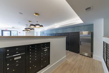 Mail room with package lockers and refrigerator