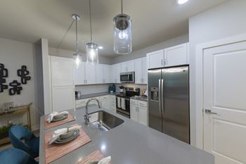 Contemporary kitchen with glass pendant lights