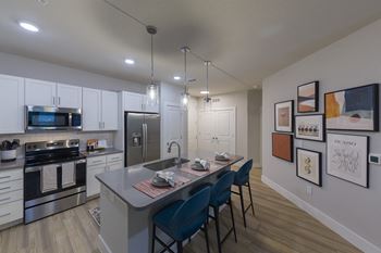Contemporary kitchen with island seating and gallery wall