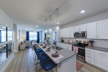 Open concept kitchen living area with island dining