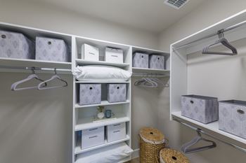Organized walk-in closet with storage baskets
