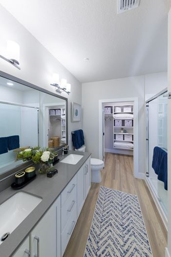 Master bathroom with double vanity and walk-in closet