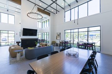 Jacksonville apartment for rent - a large living room with a large dining table and a fireplace