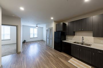 Jacksonville apartment for rent - A kitchen with black cabinets and a white countertop.
