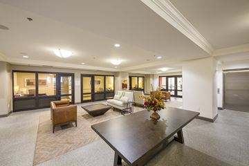 Jacksonville apartment for rent - A modern living room with a dark wood coffee table and a white couch.