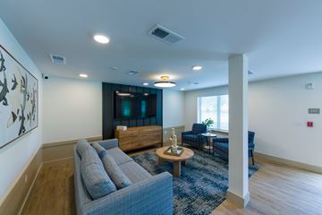 Jacksonville apartment for rent - A living room with a grey sofa and a wooden coffee table.
