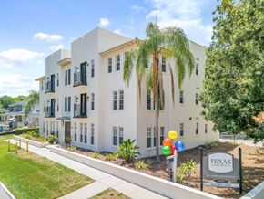 Tampa apartment for rent - a white building with palm trees in front of it
