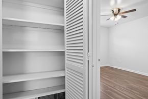 Tampa apartment for rent - a bedroom with a closet and a ceiling fan