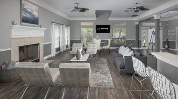 Pinellas Park apartment for rent - A living room with a fireplace and a large painting on the wall.
