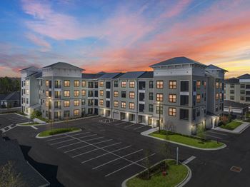 Modern apartment complex exterior at sunset