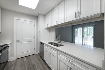 Chapel Hill apartment for rent - A kitchen with white cabinets and a window.