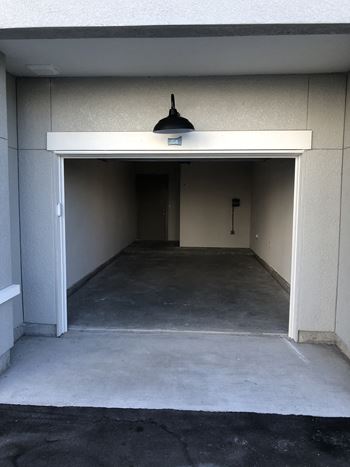 Empty garage space with concrete flooring