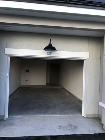Empty garage space with overhead lighting
