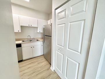 Tampa apartment for rent - A white kitchen with a refrigerator and sink.