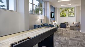 Clearwater apartment for rent - A room with a pool table and a chair.