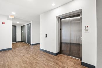 Modern elevator lobby with hardwood flooring