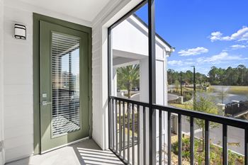 Screened balcony with green door and metal railing