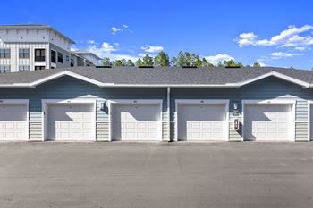 Four car garage building with white doors