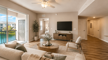 Cape Coral apartment for rent - A modern living room with a flat screen TV and a sliding glass door.