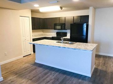 Key West apartment for rent - a kitchen with a counter and a black refrigerator