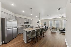 Fairburn townhouse for rent - A modern kitchen with a large island and a dining area.