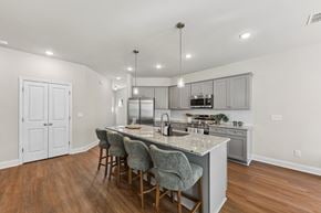 Fairburn townhouse for rent - A kitchen with a bar area and grey chairs.