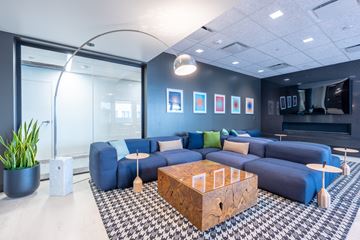 Des Moines apartment for rent - A modern living room with a blue couch and a wooden coffee table.
