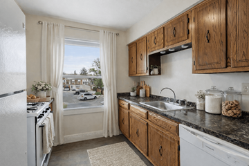 Bordentown apartment for rent - A kitchen with wooden cabinets and a white fridge.