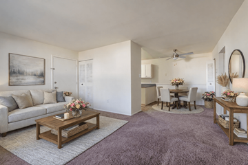 Richmond apartment for rent - A living room with a couch, coffee table, and a painting on the wall.