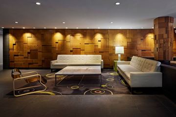 Chicago apartment for rent - A modern living room with a white sofa and a wooden backdrop.