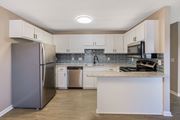 Greenville apartment for rent - A kitchen with a refrigerator, microwave, and oven.