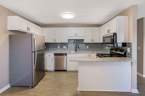 Greenville apartment for rent - A kitchen with a refrigerator, microwave, and oven.