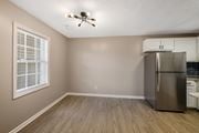 Greenville apartment for rent - A kitchen with a refrigerator and a ceiling fan.
