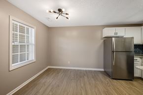 Greenville apartment for rent - A kitchen with a refrigerator and a ceiling fan.