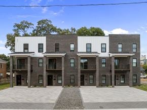 Greenville townhouse for rent - A modern building with a combination of brick and white panels.
