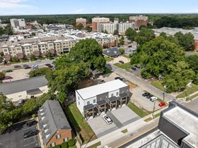 Greenville townhouse for rent - A bird's eye view of a city with buildings, cars, and trees.