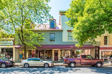 Frederick apartment for rent - a city street with cars parked in front of a building