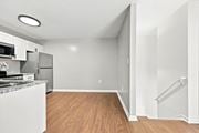 Creedmoor townhouse for rent - A kitchen with a refrigerator, microwave, and sink.