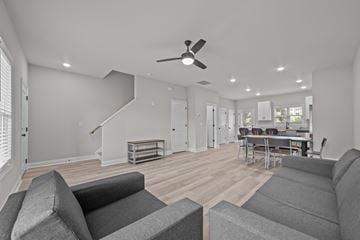 Greenville townhouse for rent - A living room with grey couches and a ceiling fan.