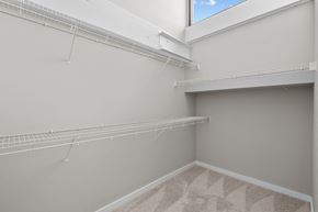 Clayton apartment for rent - a spacious closet with shelves and a large window in a home with grey walls at Spinning Mill Lofts, Clayton, NC 27520