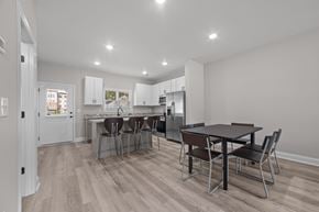 Greenville townhouse for rent - A kitchen with a table and chairs in the middle of the room.