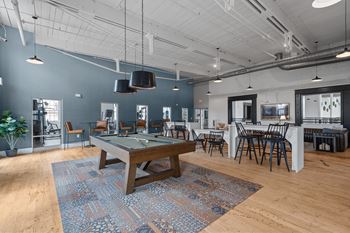 A game room with a pool table and tables