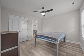 Greenville townhouse for rent - A bedroom with a bed, dresser, and mirror.