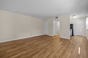 Raleigh triplex for rent - the living room and dining room of an apartment with wood flooring at Raleigh Rentals, North Carolina, 27604