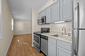Raleigh triplex for rent - an empty kitchen with white cabinets and stainless steel appliances at Raleigh Rentals, North Carolina