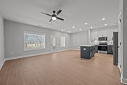 Winterville townhouse for rent - A spacious room with a ceiling fan and wooden flooring.at Regency Townes, North Carolina