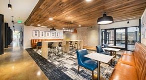 Greenville apartment for rent - A modern dining area with wooden ceiling and a black and white patterned rug.