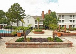 Columbia apartment for rent - A white building with a pool in front of it.